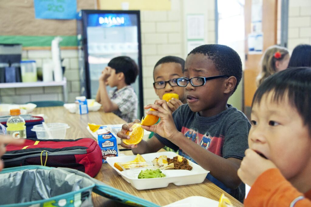 A child eating lunch in a cafeteria.